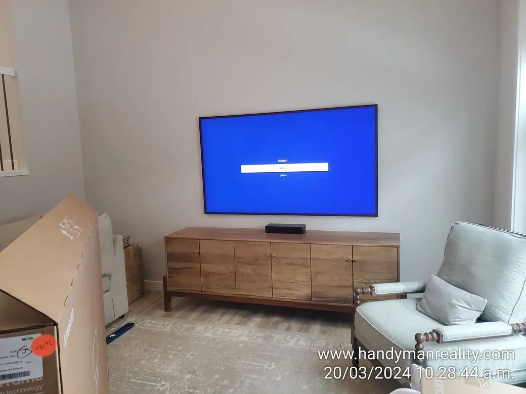 TV mounted on the wall and media console assembled